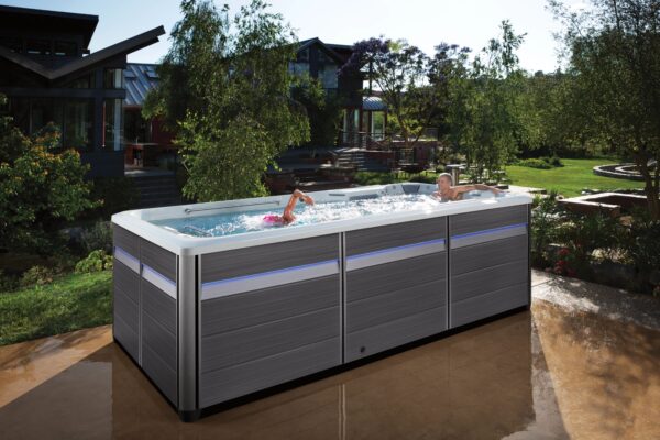 endless pools ultimate swim spa EP FitnessSystems 2023 E500 IceGray Gray Lifestyle Female Swimmer