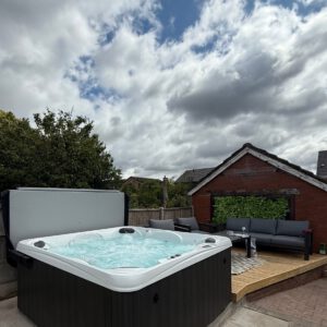 Ultimate 7 hot tub installed on a garden patio