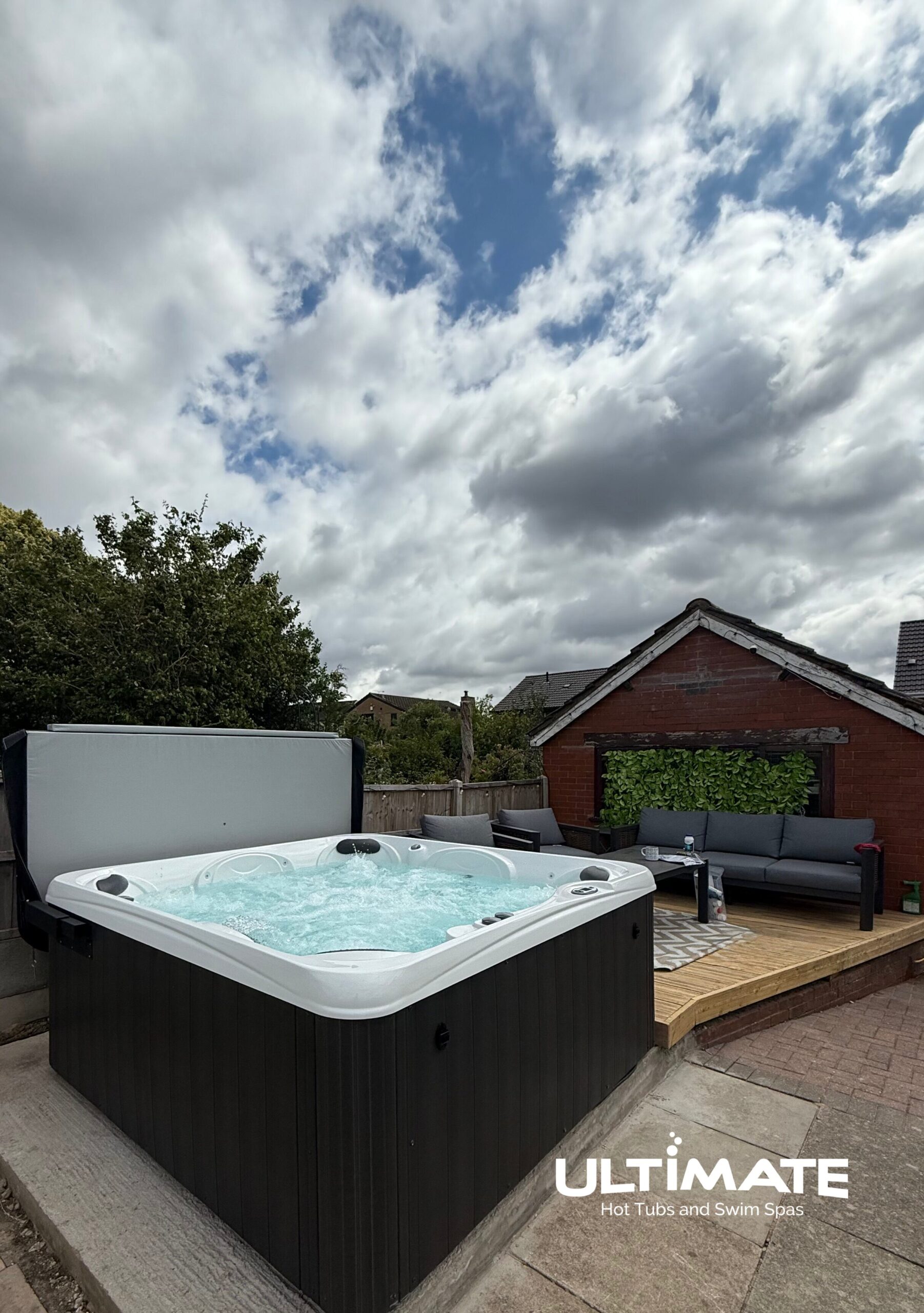 Ultimate 7 hot tub installed on a garden patio